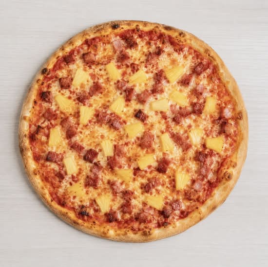 Halal Hawaiian pizza with savory halal beef bacon, pineapple chunks, and mozzarella cheese