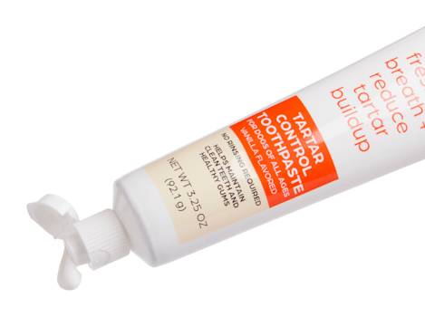 Well & Good Tartar Control Dog Toothpaste displayed with grooming tools