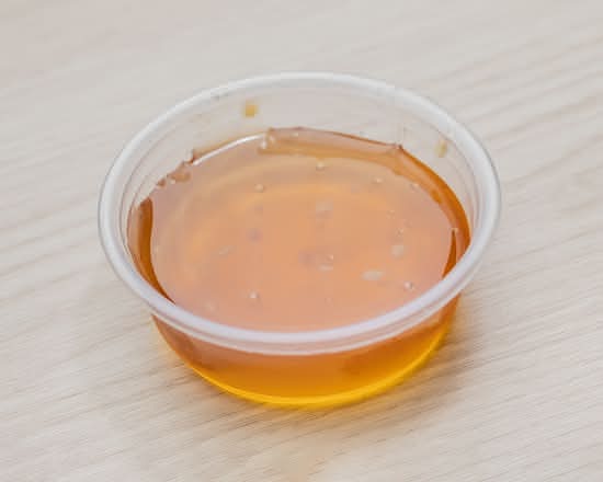 Sweet and savory honey garlic dipping sauce container