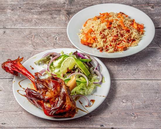 Slow cooked Xaniid lamb shank served on a bed of seasoned basmati rice with lime