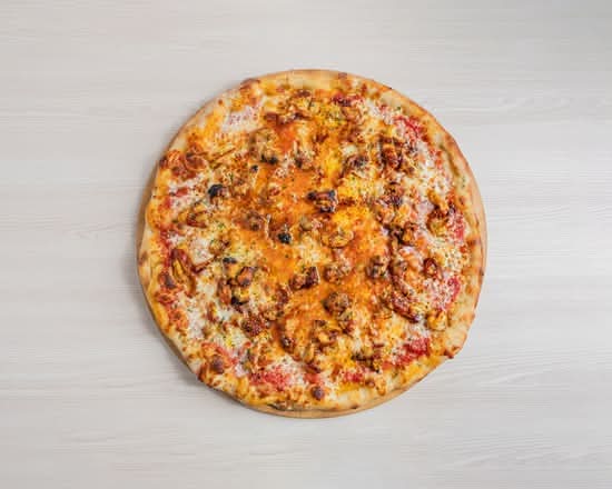 Artisanal halal BBQ chicken pizza with tender grilled chicken and sweet savory barbecue sauce