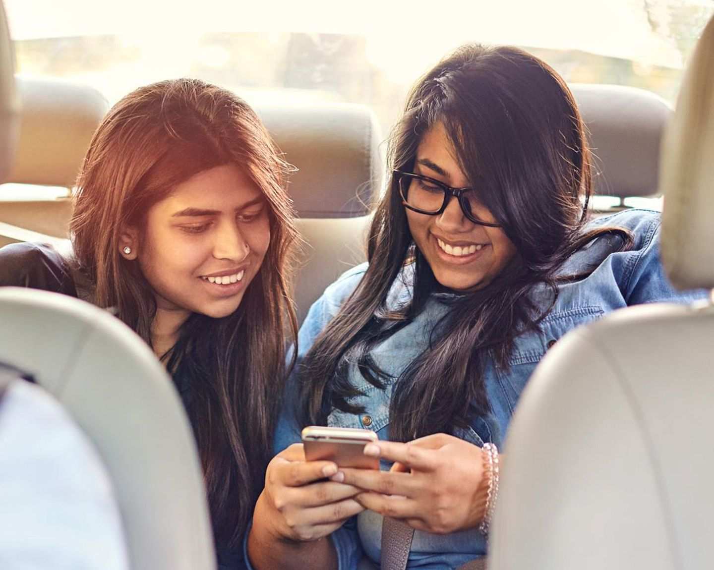 Riders using the Uber app in back of Uber ride