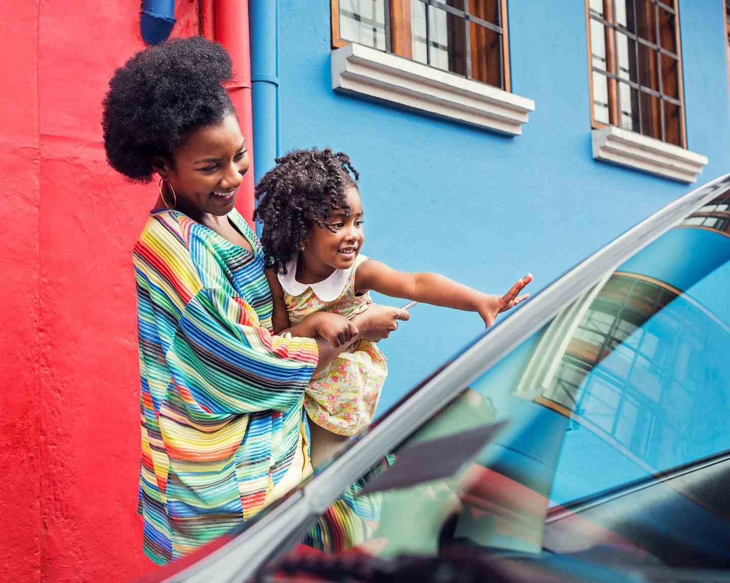 Mother and child getting into Uber ride