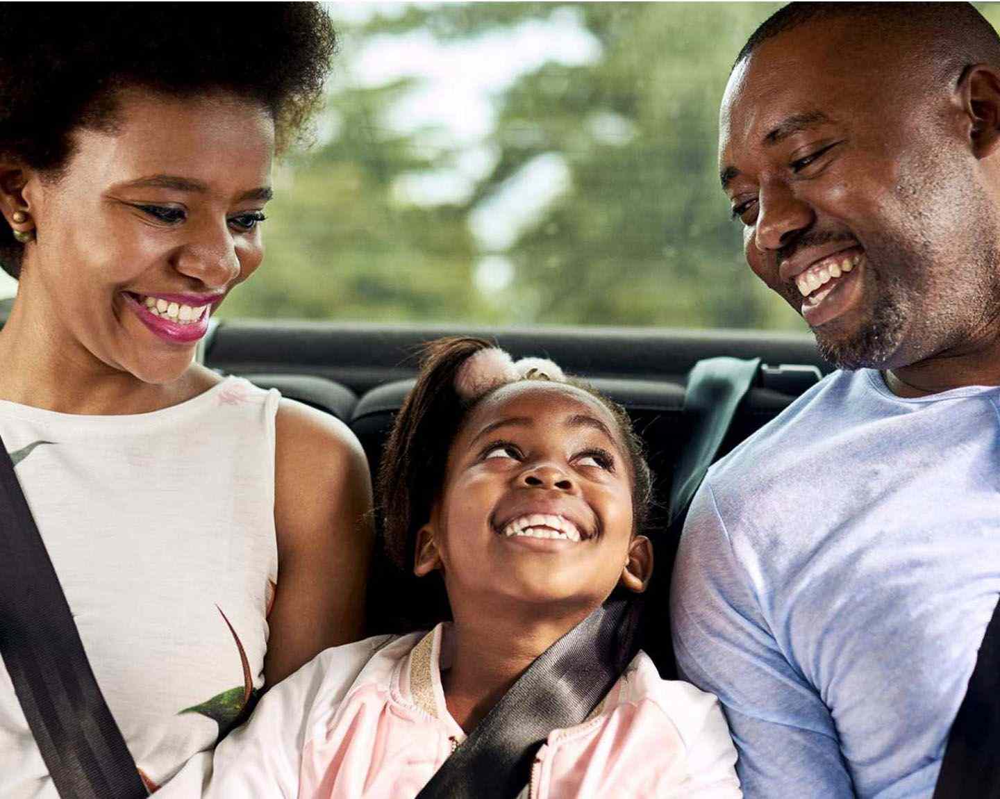 small girl and her parents inside their ride